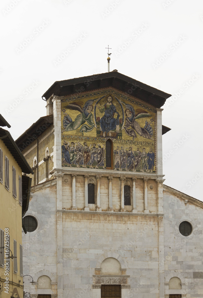 LUCCA, ITALY - AUGUST 15 2015: Architectural close up of the upper facade of Ancient Basilica of San Frediano in Old Lucca town, Italy