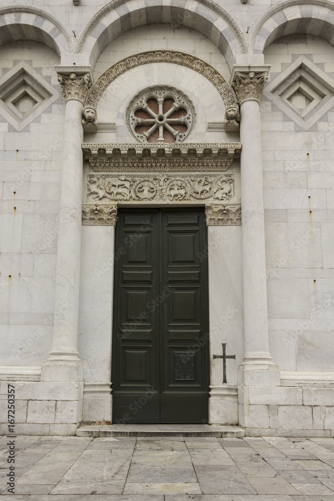 LUCCA, ITALY- AUGUST 15 2015: Architectural close up of the doorway to San Michele church in Lucca, Italy