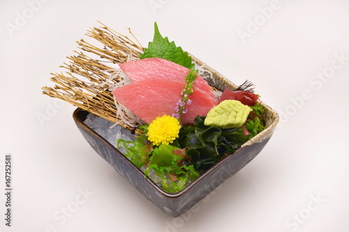 Otoro Sashimi Slice in black bowl on white background photo