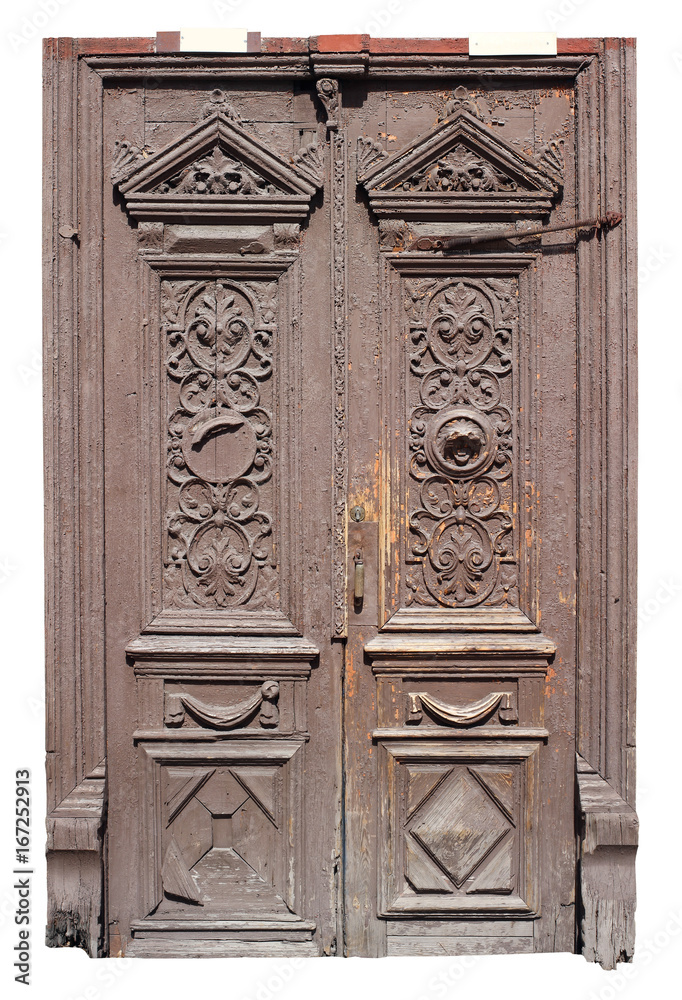 A very old archaic wooden door and frame is painted brown.