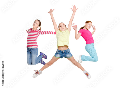 Happy kids jumping at studio, copy space