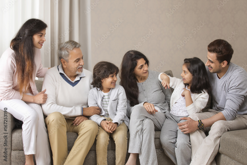 Smiling multi-generation family sitting on sofa Smiling multi-generation family sitting on sofa