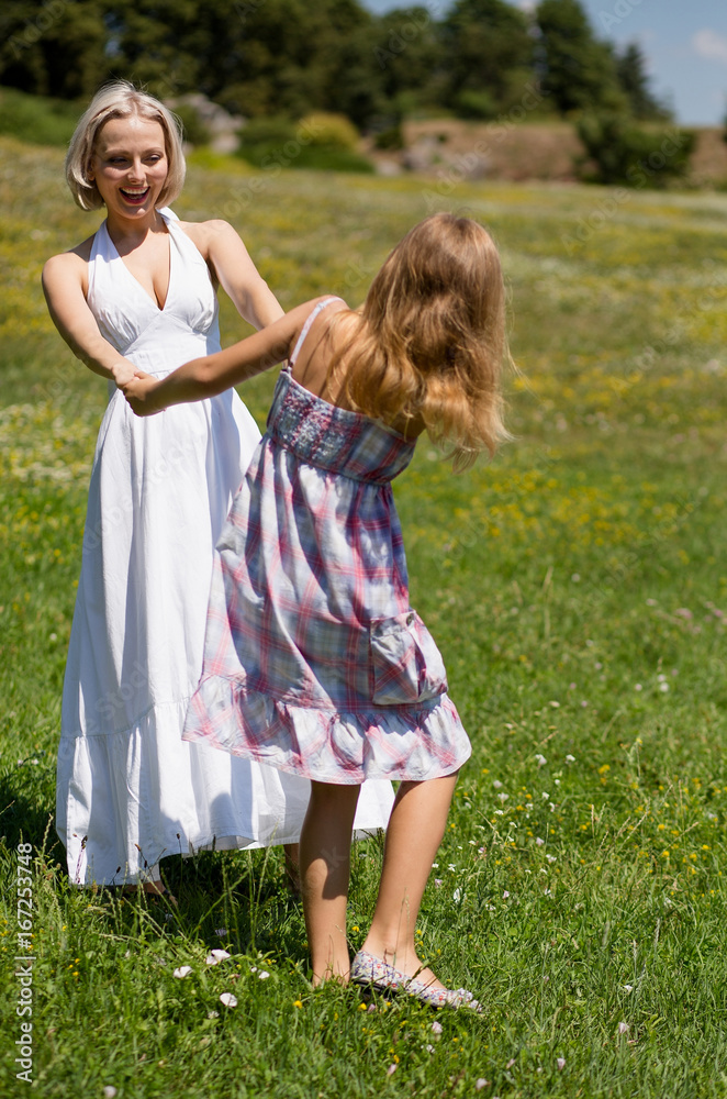 Family concept, mother spending day in nature with her girl. Mom and daughter in field having fun and dancing. Family concept, mother spending day in nature with her girl. Mom and daughter in field having fun and dancing.