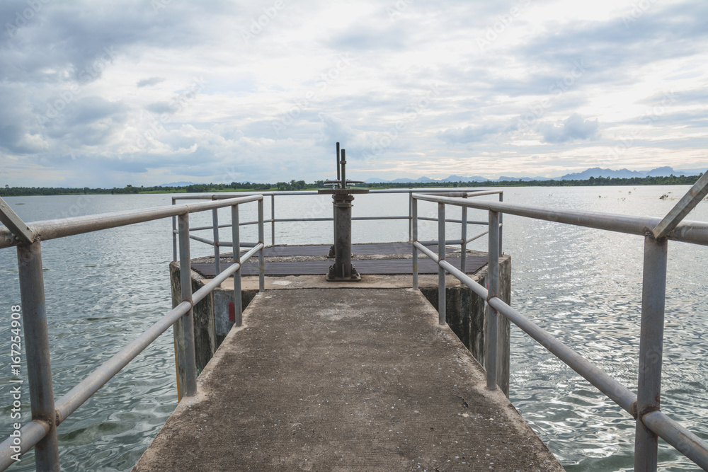 The floodgates on a dam in a river from in Thailand. Floodgate construction. The floodgates on a dam in a river from in Thailand. Floodgate construction.