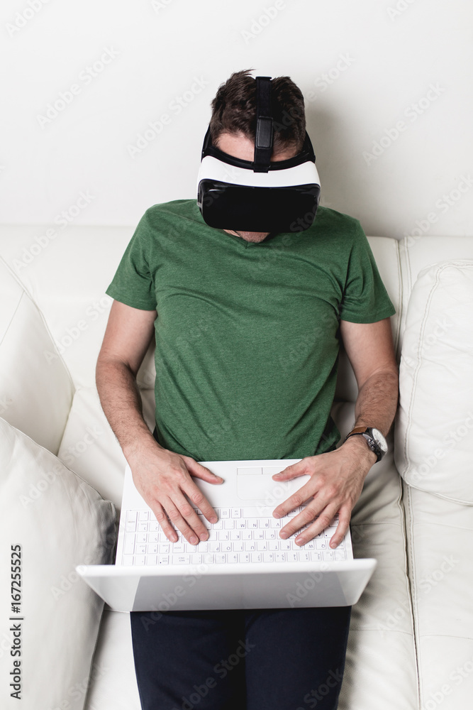 Young man using virtual reality headset or glasses. Young man using virtual reality headset or glasses.