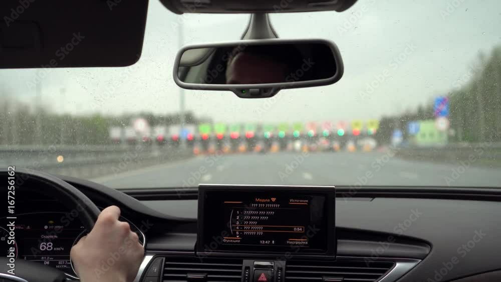 The car drives up to the toll road The car drives up to the toll road