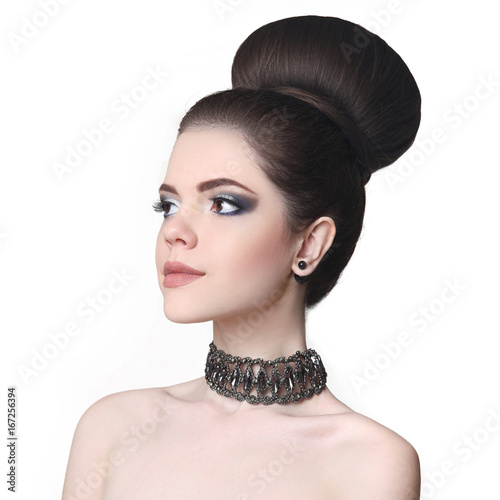Beauty makeup girl. Fashion bun hairstyle. Attractive teen brunette with choker isolated on studio white background.