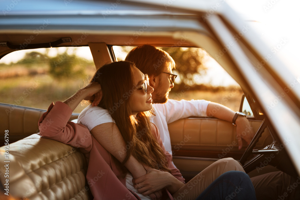 Fotografie Young beautiful couple relaxing together while sitting