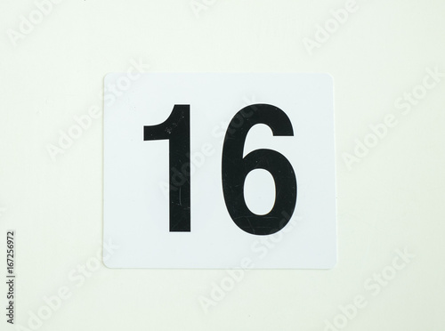 sixteen number sign on white paper