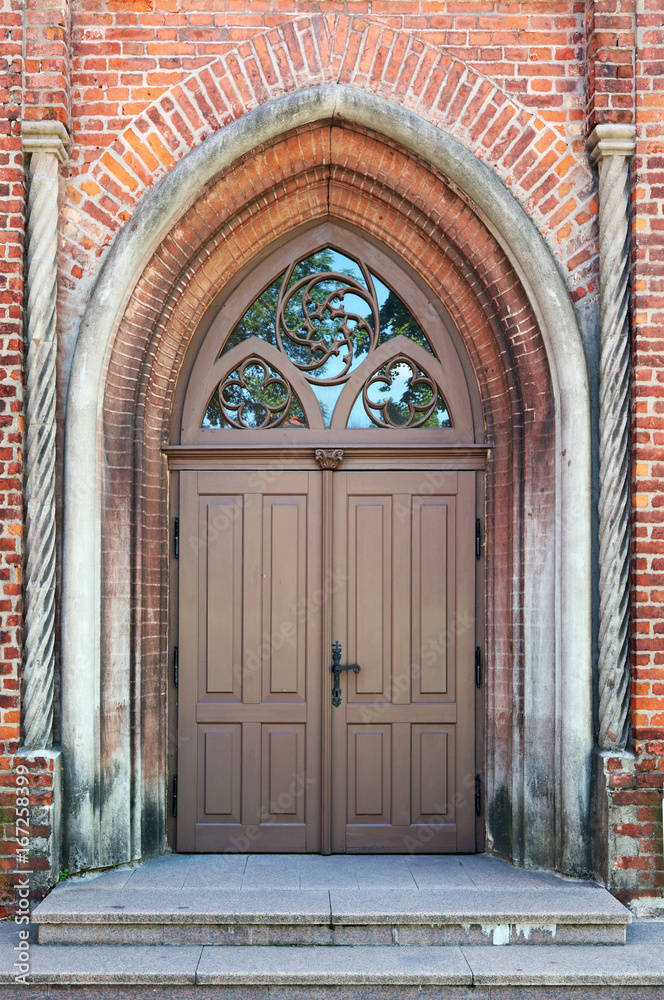 The central front door to the old public medieval brick church