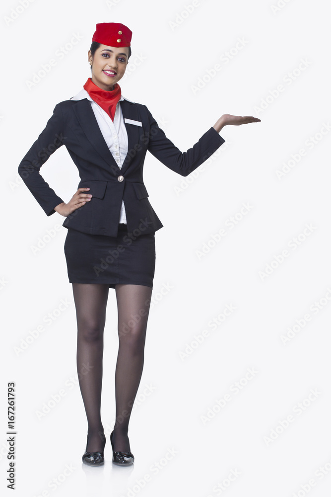 Portrait of an airhostess holding invisible product isolated over white background Portrait of an airhostess holding invisible product isolated over white background