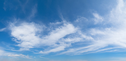 Panoramic blue sky background with white clouds on a sunny day