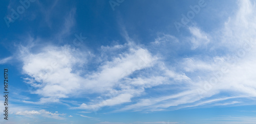 Panoramic blue sky background with white clouds on a sunny day