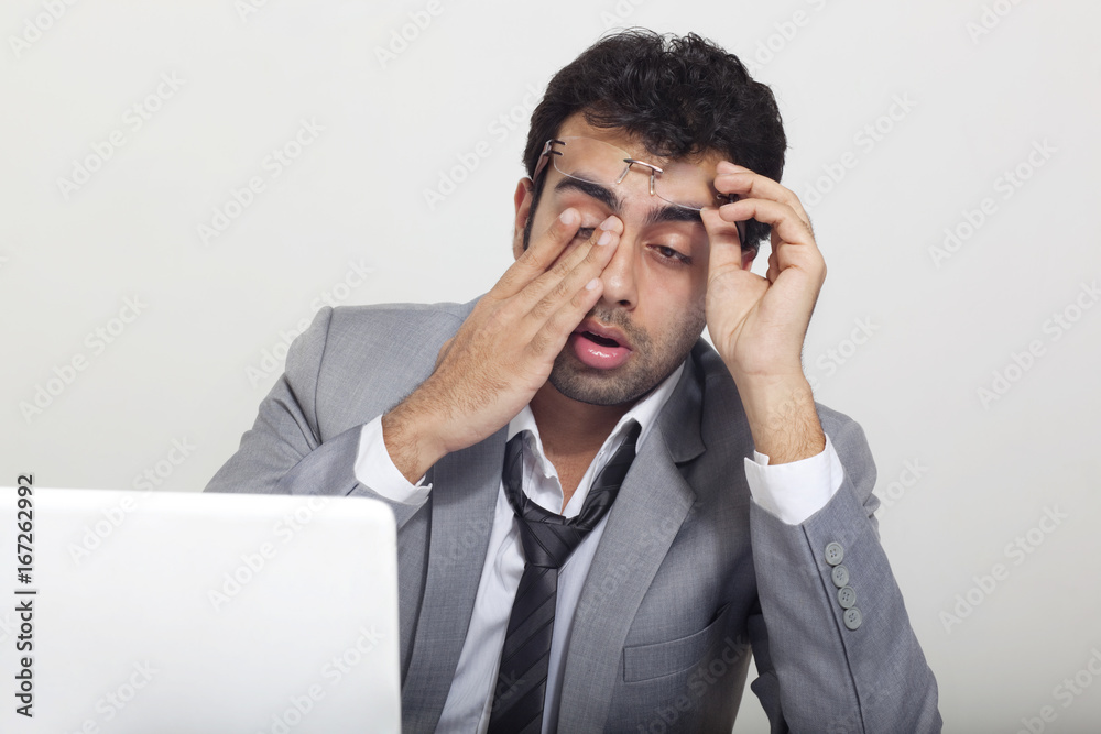 Businessman feeling sleepy at work Businessman feeling sleepy at work