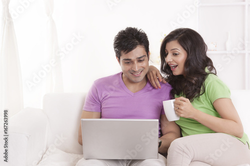 Couple sitting with laptop