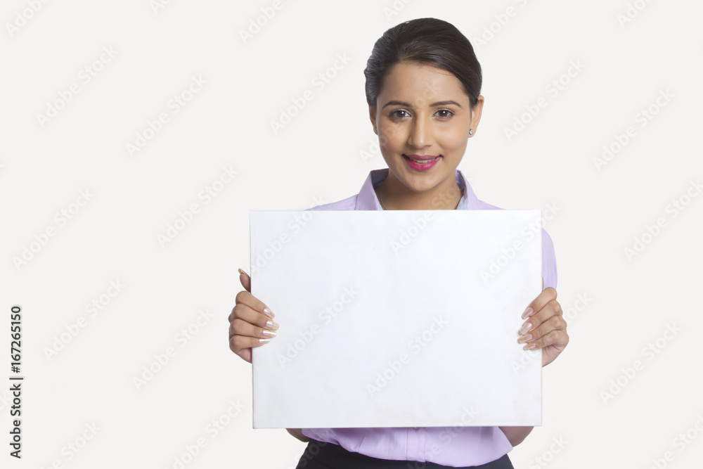 Portrait of confident businesswoman holding blank placard against white background Portrait of confident businesswoman holding blank placard against white background
