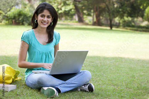 Portrait of college student using laptop 