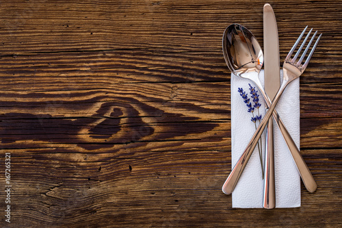 Spoon knife fork on old wooden table