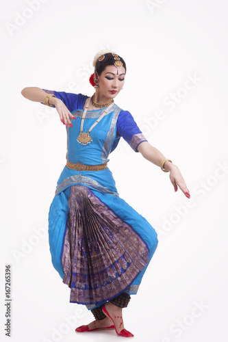 Photography Full length of beautiful woman performing Indian Bharat Natyam dance on white ba