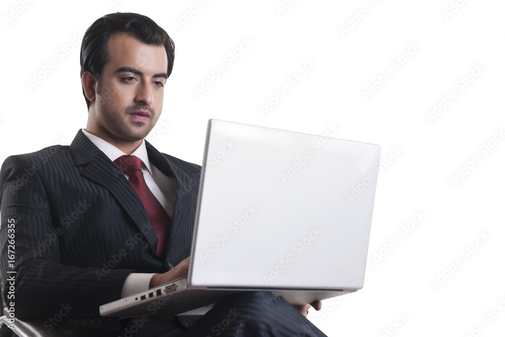 Young businessman using laptop over white background Young businessman using laptop over white background
