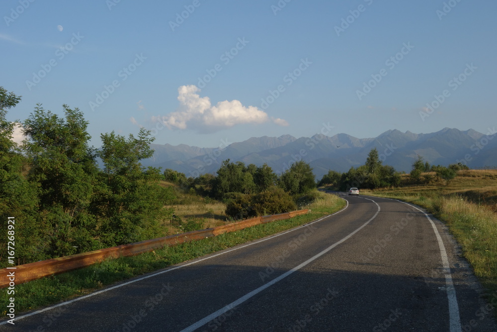 Road in Transylvania, Romania with Fagaras mountains in the background