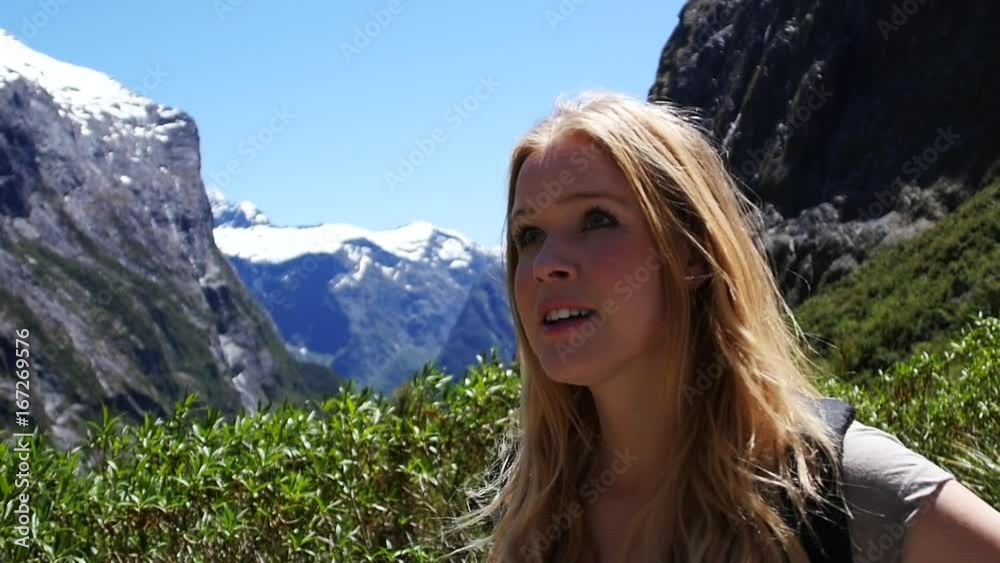 Slow motion, young blonde woman backpacking New Zeland travel lifestyle