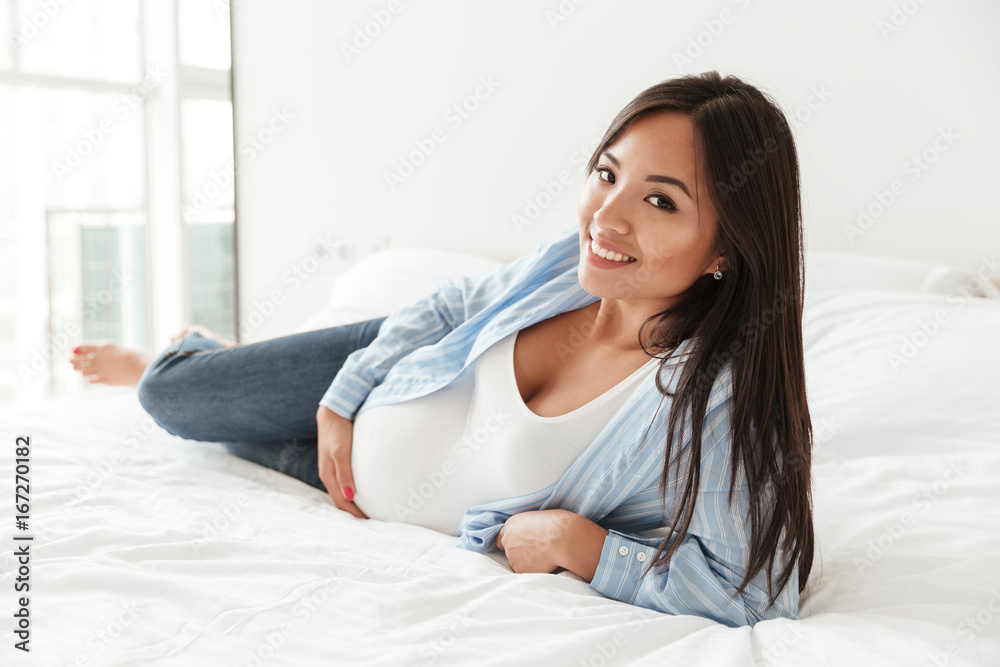 Cheerful young pregnant woman at home Cheerful young pregnant woman at home