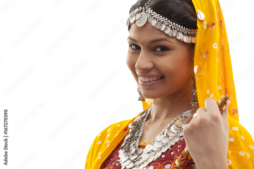 Close-up portrait of happy young woman in Dandiya Raas outfit over white background