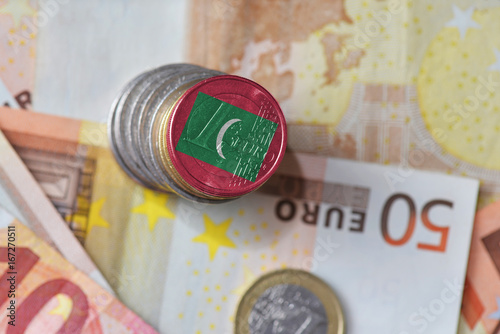euro coin with national flag of maldives on the euro money banknotes background.