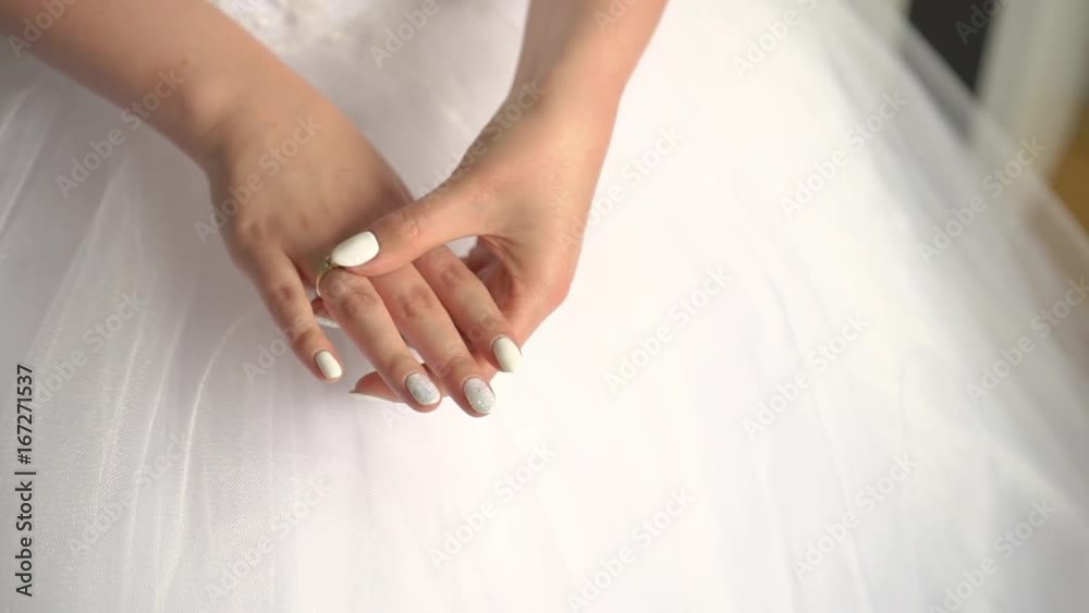 Closeup hands of a bride with an engagement ring and a wedding manicure. Indoor. Close up. Move. Closeup hands of a bride with an engagement ring and a wedding manicure. Indoor. Close up. Move.
