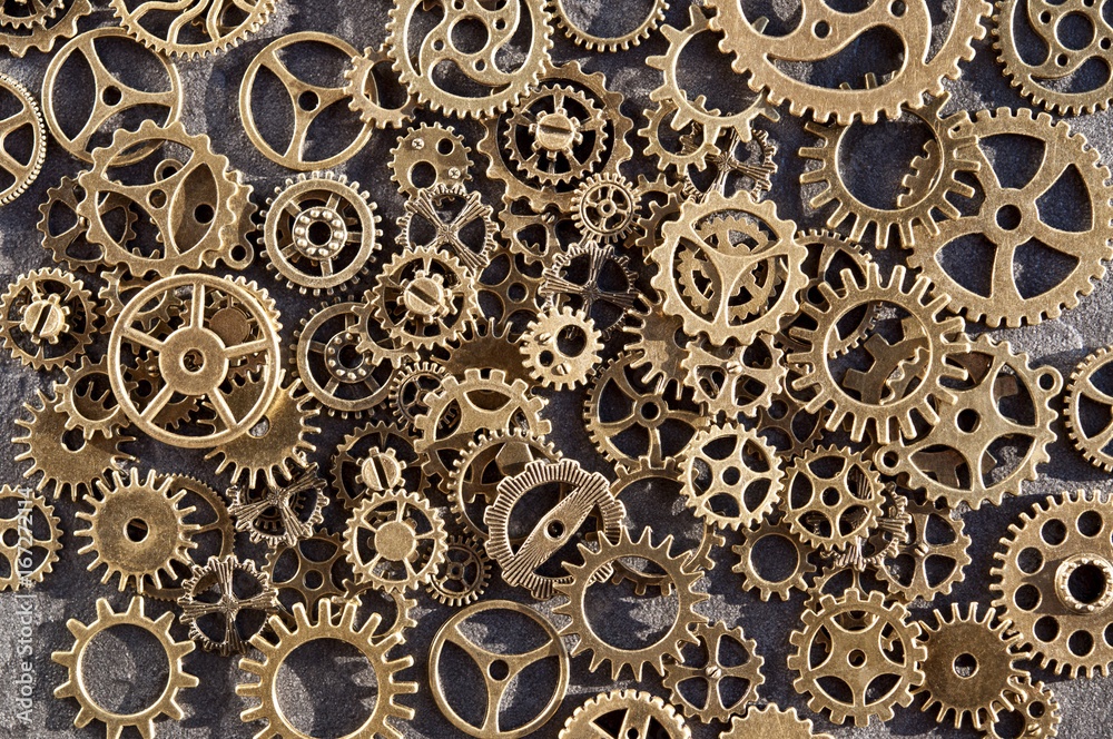 Gears are scattered on a stone background.