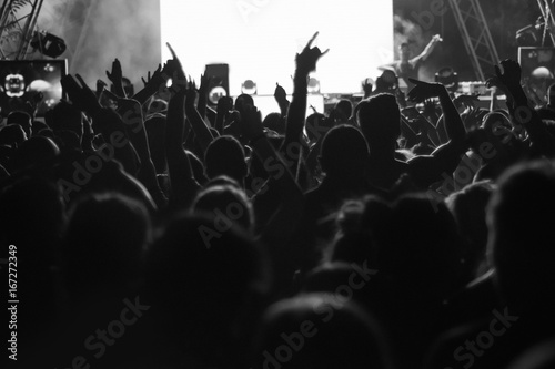 Blur background of concert crowd in front of bright stage lights musics