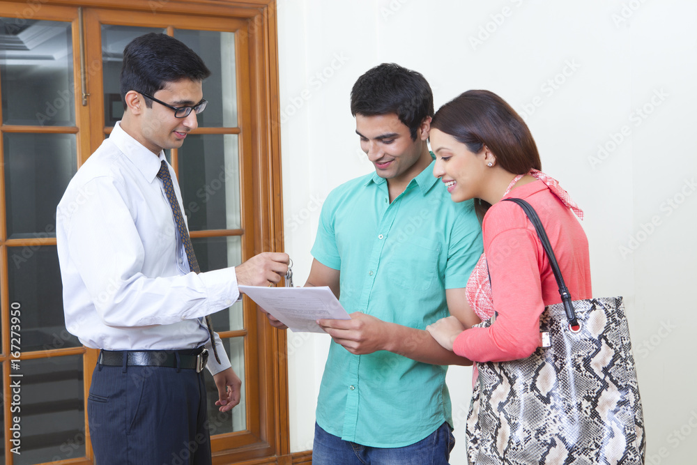 Agent selling property to young couple Agent selling property to young couple