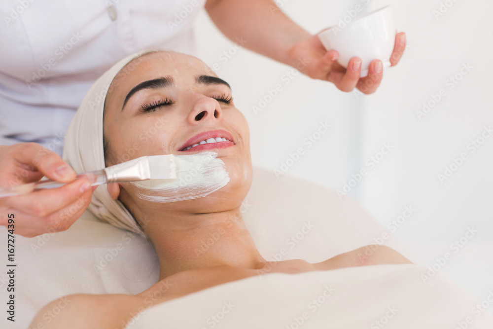 Spa facial mask application. Spa beauty organic facial mask application at day spa salon. Beauty treatment in spa salon.