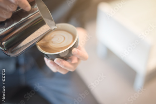 coffee latte art in coffee shop vintage color tone blur
