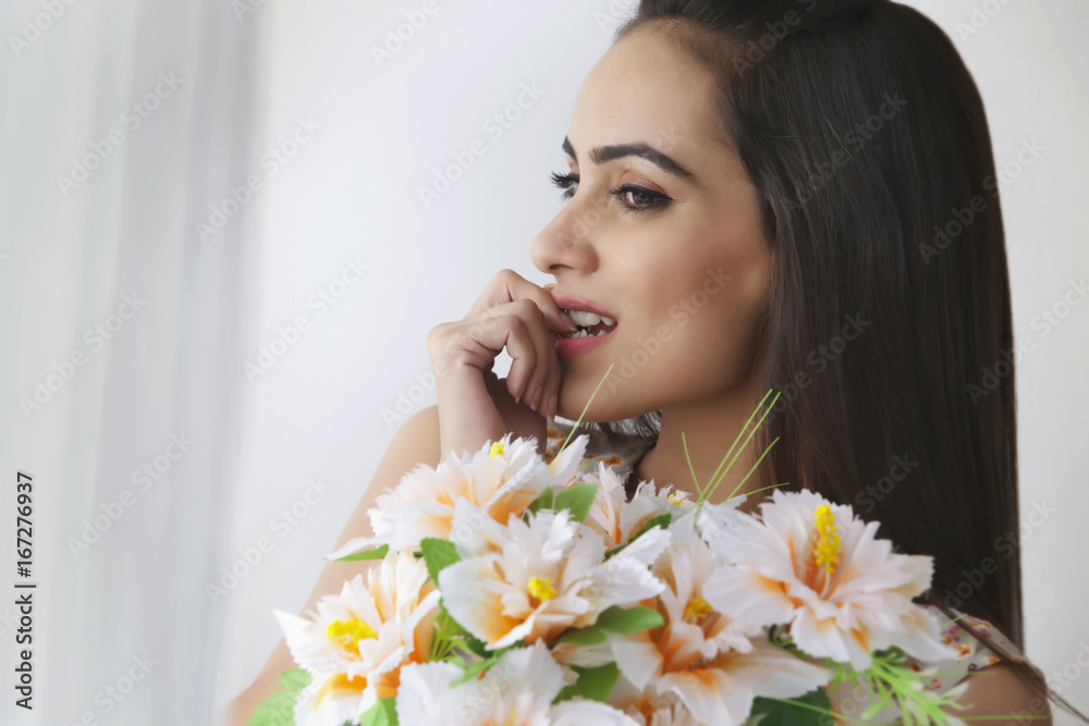 Thoughtful young woman with bunch of flowers Thoughtful young woman with bunch of flowers