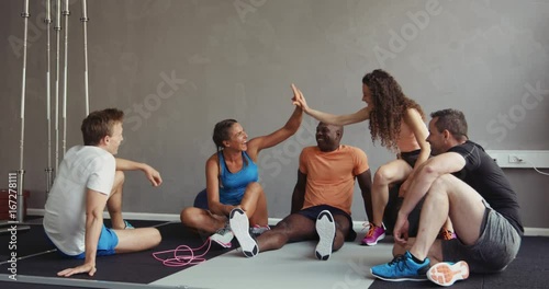 Group of friends talking together after a gym workout