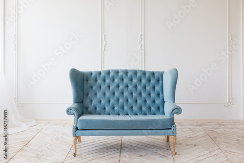 Fotografija Blue soft sofa in white interior with fabric upholstery