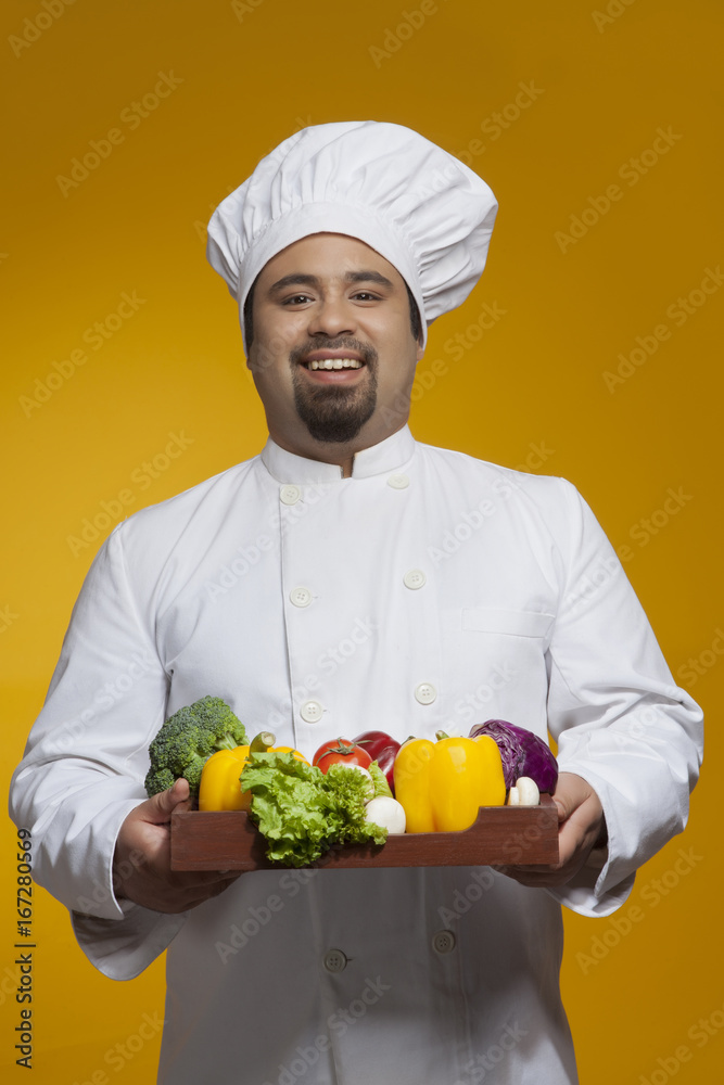 Portrait of chef with tray of vegetables Portrait of chef with tray of vegetables