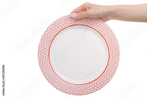 Plate with red and white edging in a female hand