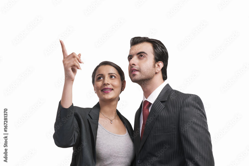 Beautiful businesswoman showing something to colleague over white background Beautiful businesswoman showing something to colleague over white background