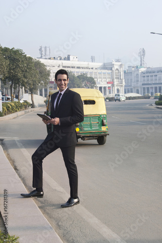 Businessman holding a digital tablet , INDIA , DELHI