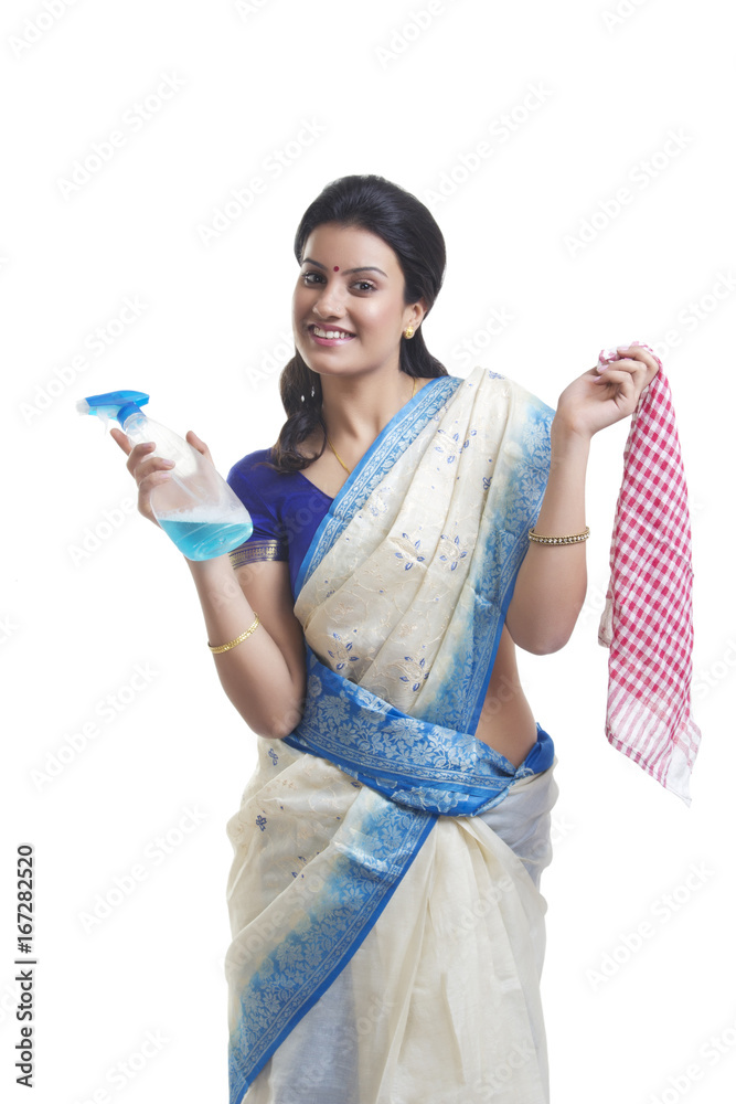 Portrait of housewife with spray bottle and cloth Portrait of housewife with spray bottle and cloth