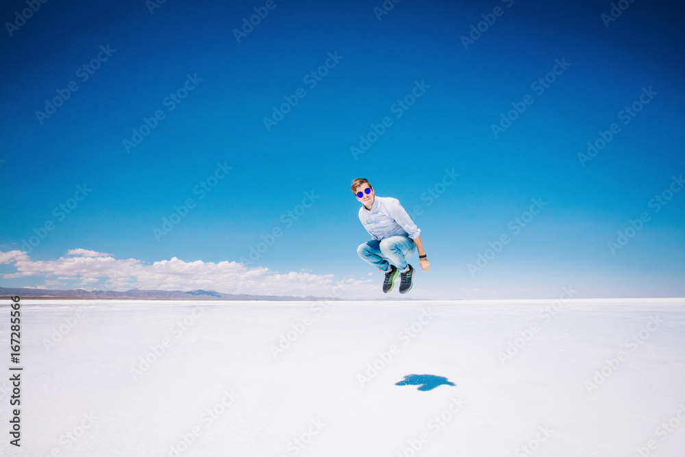 Boy jumping in Uyuni salt flats
