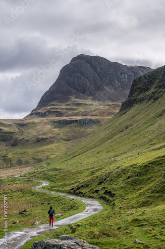 One person hiking in Scotland on Skye island, Highlands. Journey towards the Mountains