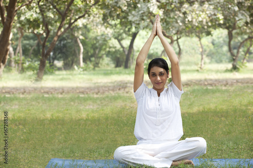 Young woman doing yoga with arms raised  © IndiaPix