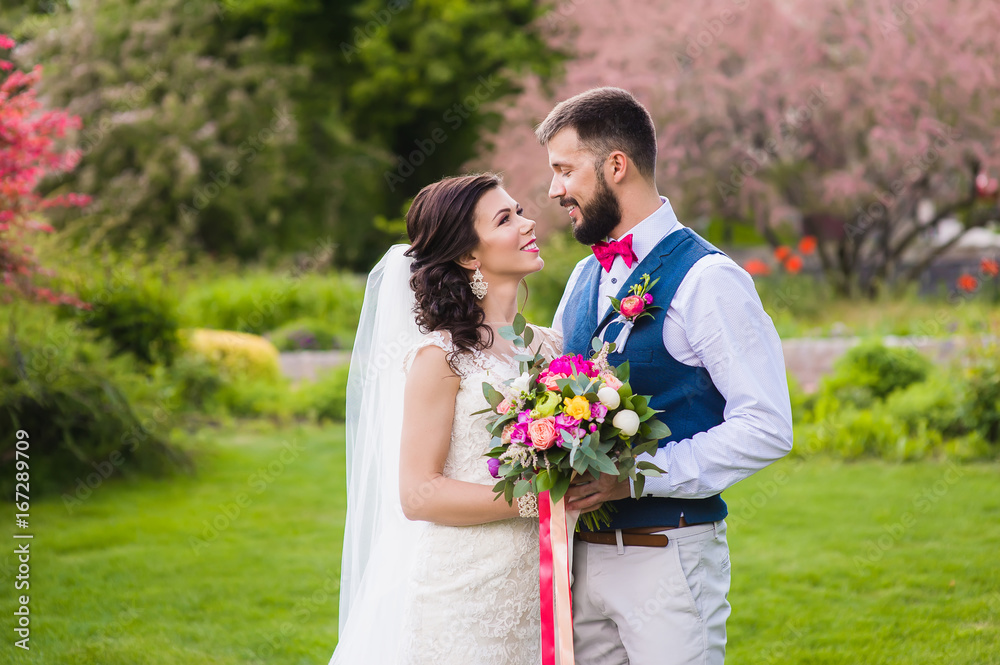 Happy newlyweds on the green lawn Happy newlyweds on the green lawn