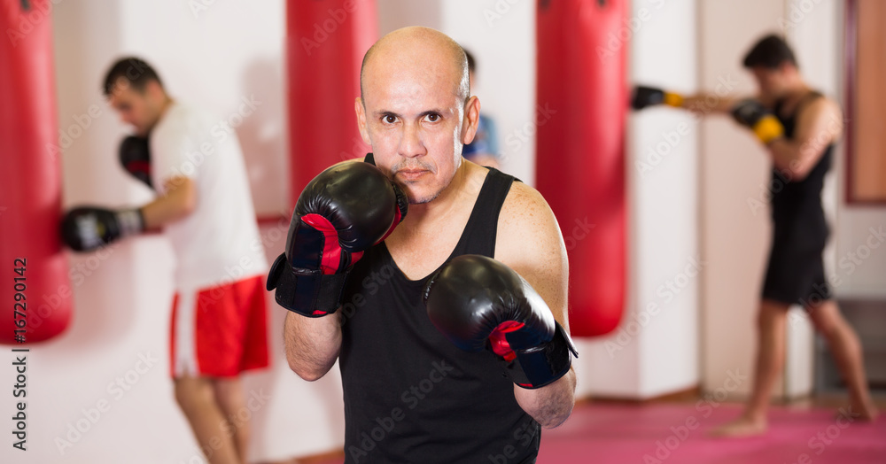 adult sportsman in the boxing hall practicing boxing punches