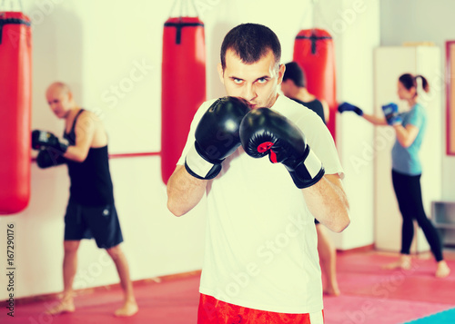 serious sportsman in the boxing hall practicing boxing punches