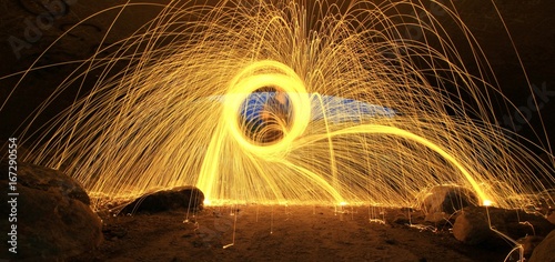 Creating spirals, loops and trails of fire with steel wool photography.